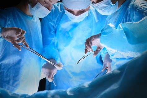 Premium Photo Group Of Surgeons At Work In Operating Theater Toned In