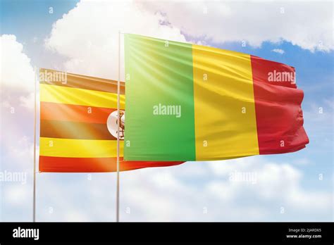 Sunny Blue Sky And Flags Of Mali And Uganda Stock Photo Alamy