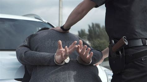 Policeman Arresting Criminal On Parking Lot Stock Image Image Of Mission Reading 102200655