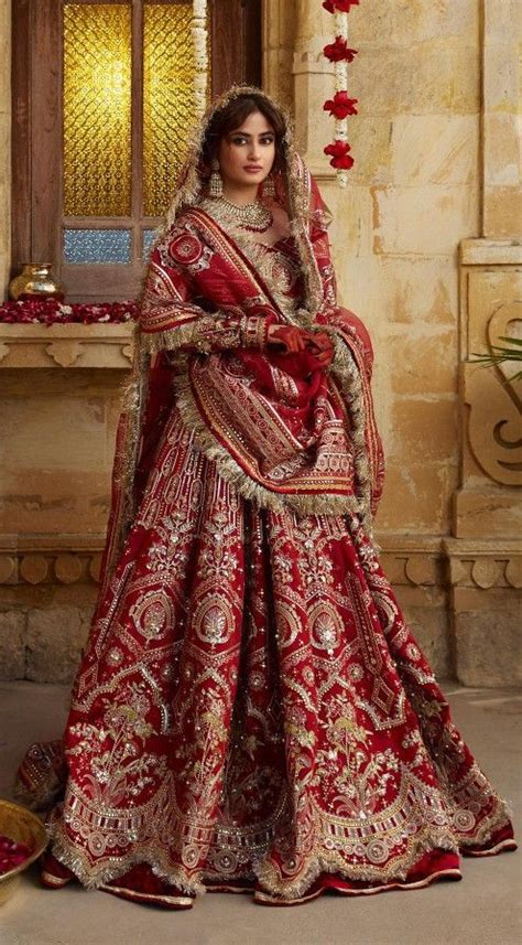 A Woman In A Red And Gold Bridal Gown