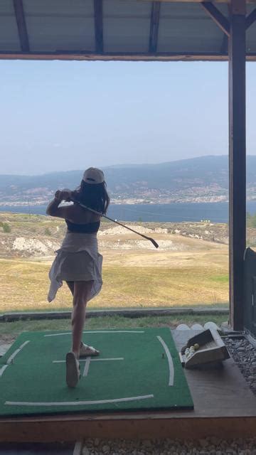 Girl In Hat Swinging Golf Club Over Mountain Gridbank