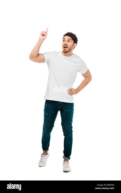 Full Length View Of Young Man Standing With Hand On Waist And Pointing