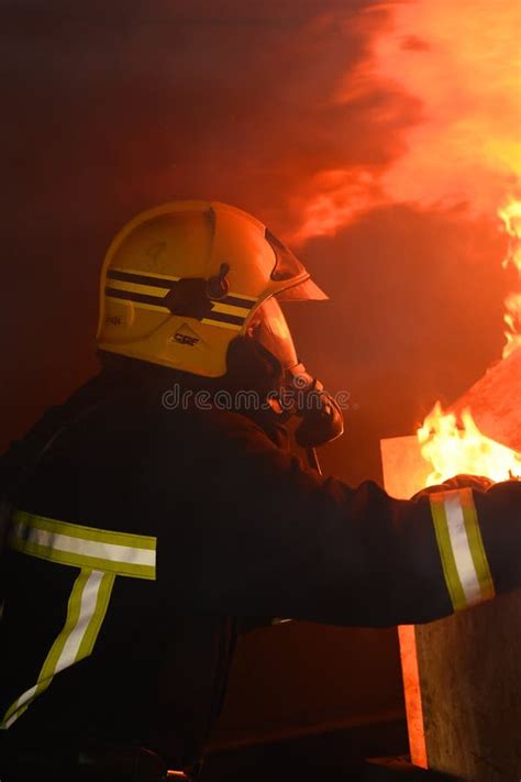 Firefighter Tackles Flames In A Burning Building Editorial Photo