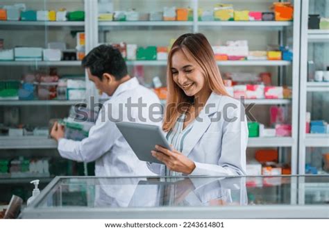 Asian Female Pharmacist Uniform Working Using Stock Photo 2243614801 ...