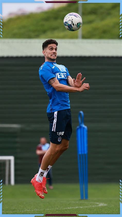 A Man Jumping Up To Catch A Soccer Ball In The Air With His Hands And Feet