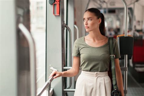 Displeased Woman Commuter Standing Inside Modern Tram Facing Commuting ...