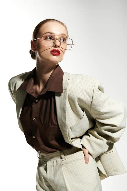 Premium Photo | Stylish Woman in a White Suit and Glasses