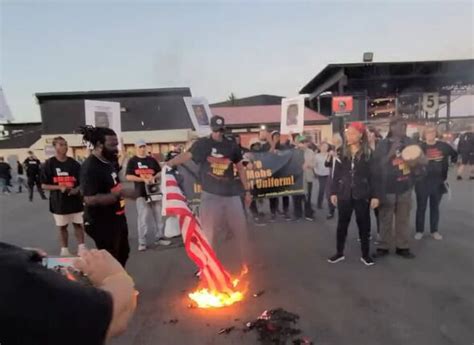 Communist revolutionaries burn and stomp on American flags in protest ...