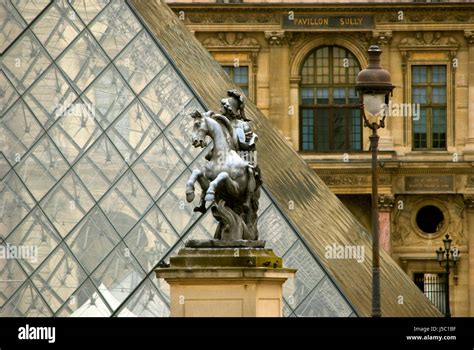 Statue in front of Louvre museum, Paris Stock Photo - Alamy