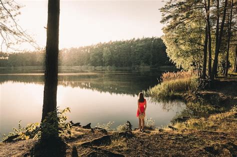 Premium Photo Rear View Of Woman Standing On Lakeshore