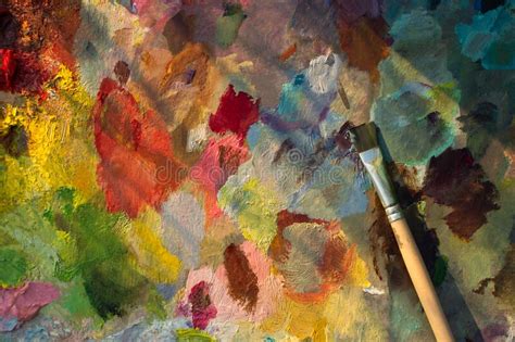 An Artist`s Palette With An Oil Paint Brush Close Up Blurry