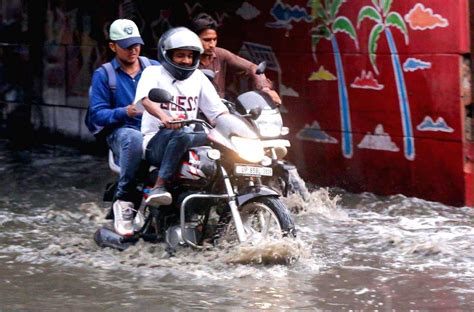 Vehicles Wade Through A Waterlogged Road