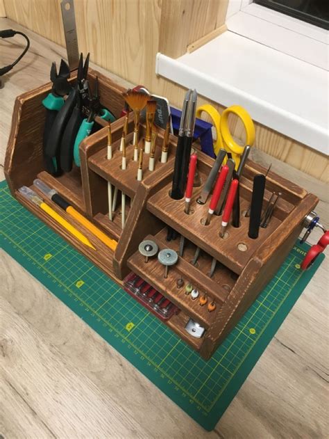 The Tools Are Organized Neatly In This Wooden Tool Holder On The