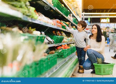 Mother And Her Son Buying Fruits At A Farmers Market Stock Image