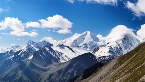 Majestic Mountain Range With Snow Capped Peaks Basking In The Sunlight