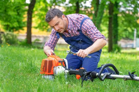 One Gardener Mowing Grass Fixing Brush Cutter Problem Stock Image