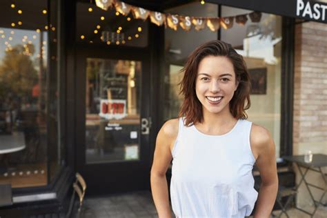 Female Business Owner Standing In The Street Outside Cafe Clearworks