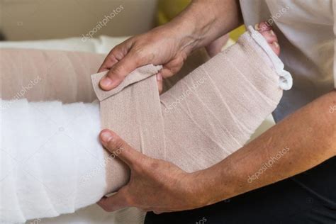 Woman Bandaging Patients Legs — Stock Photo © Vpardi 113158542