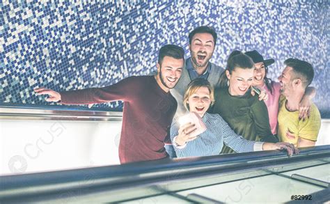 Happy Friends Taking Selfie Snapshot With Instant Camera On Subway