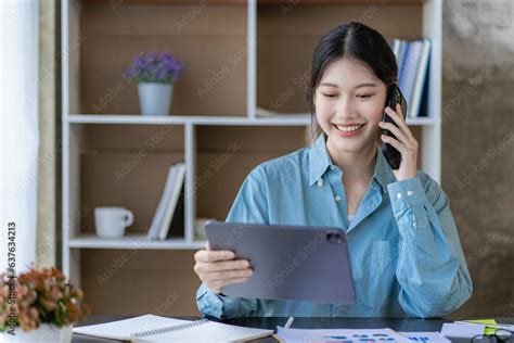 Attractive Asian Female Employee Or Female Accountant Talking On The