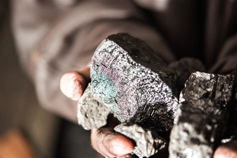 Premium Photo | Coal mining coal miner in the man hands of coal ...