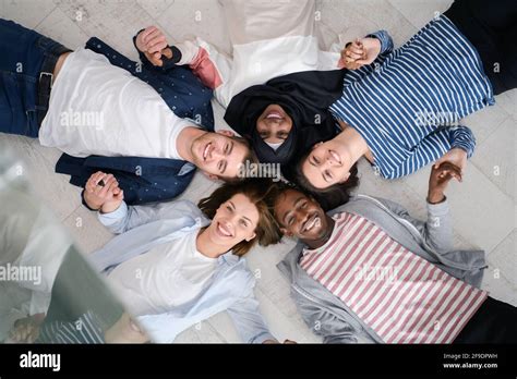 Top View Of A Diverse Group Of People Lying On The Floor And