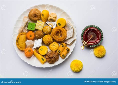 Indian Sweets Or Mithai For Diwali Festival With Oil Lamp Or Diya And