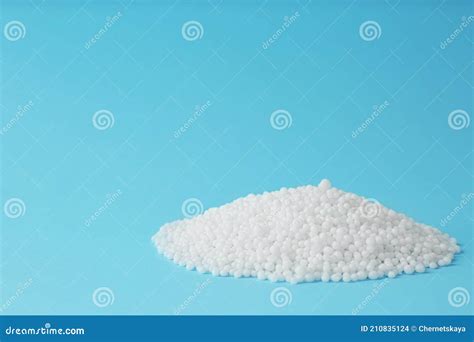 Pellets Of Ammonium Nitrate On Light Blue Background Space For Text