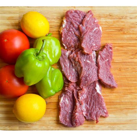 Clean Red Raw Cow Meat Beef And Fresh Vegetables On Bamboo Cutting