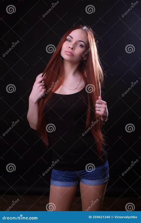 Portrait Of A Beautiful Young Red Haired Girl On A Dark Black