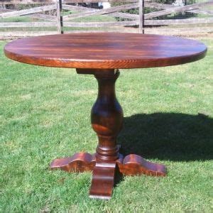 A Wooden Table Sitting On Top Of A Lush Green Grass Covered Field Next