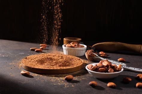 Bowls With Organic Cocoa Powder And Aromatic Raw Cocoa Beans On Dark Rustic Wooden Background