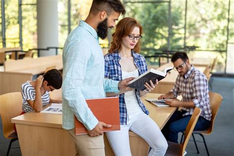 Happy Group Of Students Studying And Working Together In A College