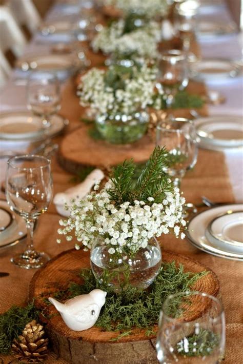 Picture Of a wood slice with greenery, baby’s breath and evergreens in ...