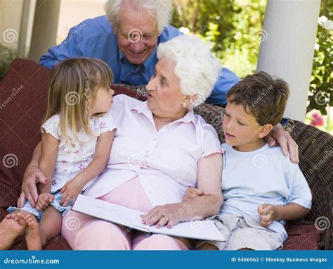 Grandparents Reading To Grandchildren Stock Photo Image Of Grandson