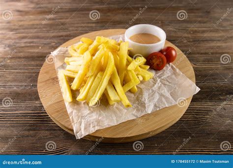 Fried Potato With Tomato Sauce On Paper Circle Board And Table Stock