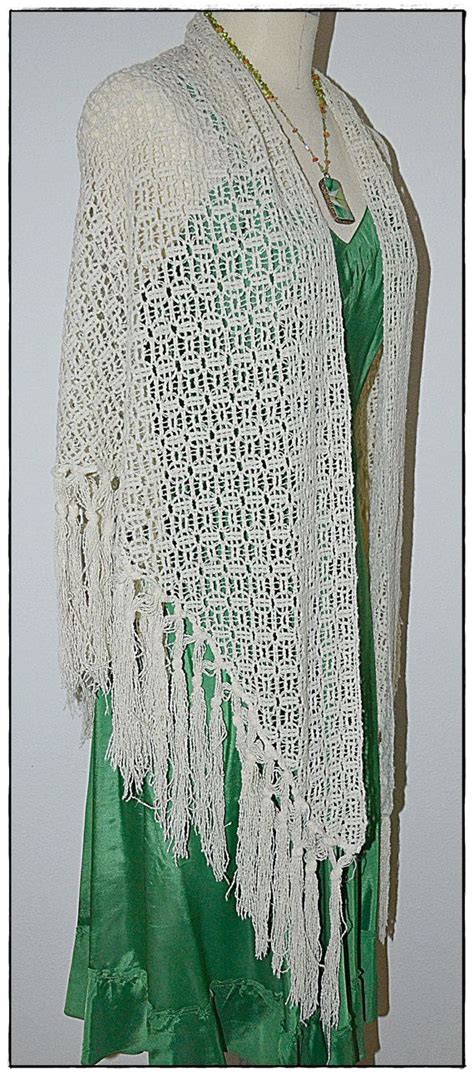 A White Crocheted Shawl With Tassels