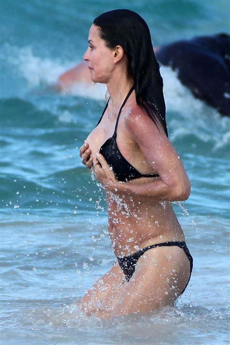 Courteney Cox Nipple Slip And Looking Very Sexy In Black Bikini On