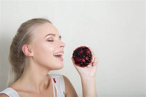 Premium Photo Cute Blonde Lady Enjoying Sweet Dessert With Berries Space For Text