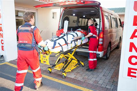 Paramedics Lifting Patient From Ambulance Stock Image F