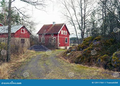 Classic Traditional Red Wooden House In Scandinavia Countryside