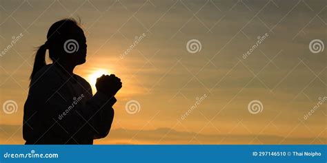 Silhouette Of Woman Kneeling Down Praying For Worship God At Sky