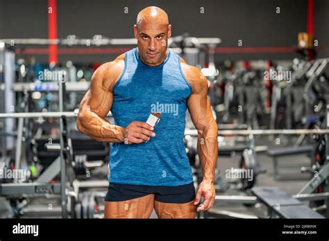 Muscular Bodybuilder Holding Protein Bar In Gym Stock Photo Alamy