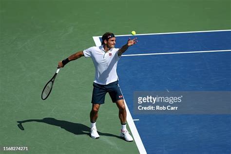 Roger Federer Of Switzerland Serves To Andrey Rublev Of Russia During