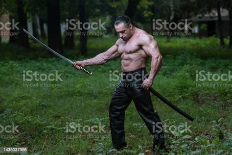 Portrait Of A Muscular Ancient Warrior With Sword Stock Photo