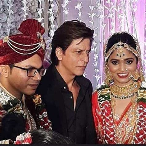 Shah Rukh Khan happily poses for pictures as he attends a wedding ...