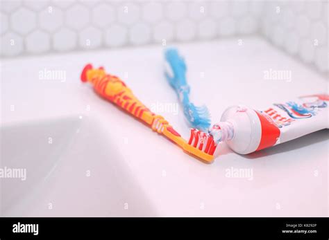 Toothpaste And Toothbrushes On A Sink In A Bathroom Stock Photo Alamy