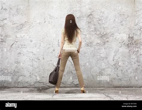 Woman Standing In Front Of Wall Stock Photo Alamy