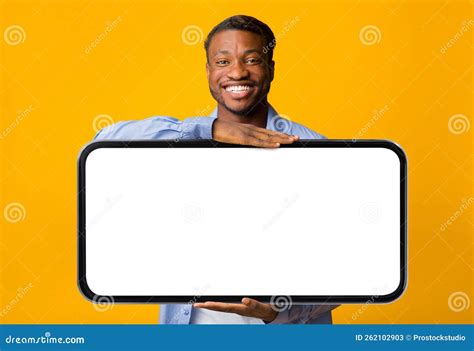 Handsome Black Man Holding Big Blank Smartphone With Empty White Screen