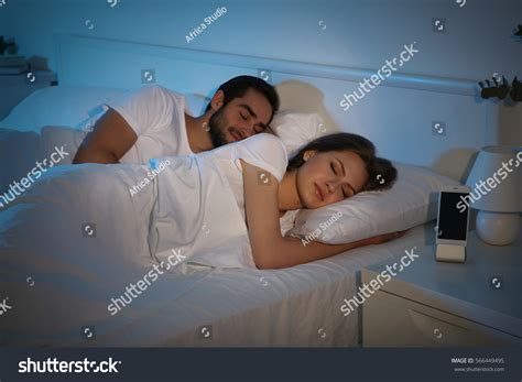 Стоковая фотография 566449495 Young Cute Couple Sleeping Together Bed